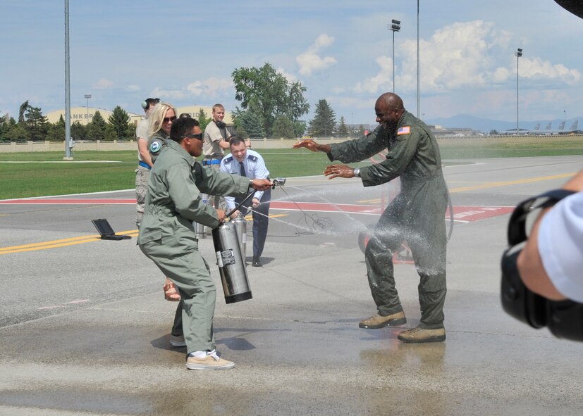 Col. Brian Hill, 92nd Air Refueling Wing vice commander, gets sprayed down with water by his son, Brayden Hill, U.S. Air Force Academy cadet, his wife, Suzette Hill, and Col. Brian McDaniel, 92nd ARW commander, May 29, 2015, at Fairchild Air Force Base, Wash. Hill was not aware of his son being in town until the moment he taxied in, his son having flown in to surprise him after his final flight. (U.S. Air Force photo/Airman 1st Class Taylor Bourgeous)