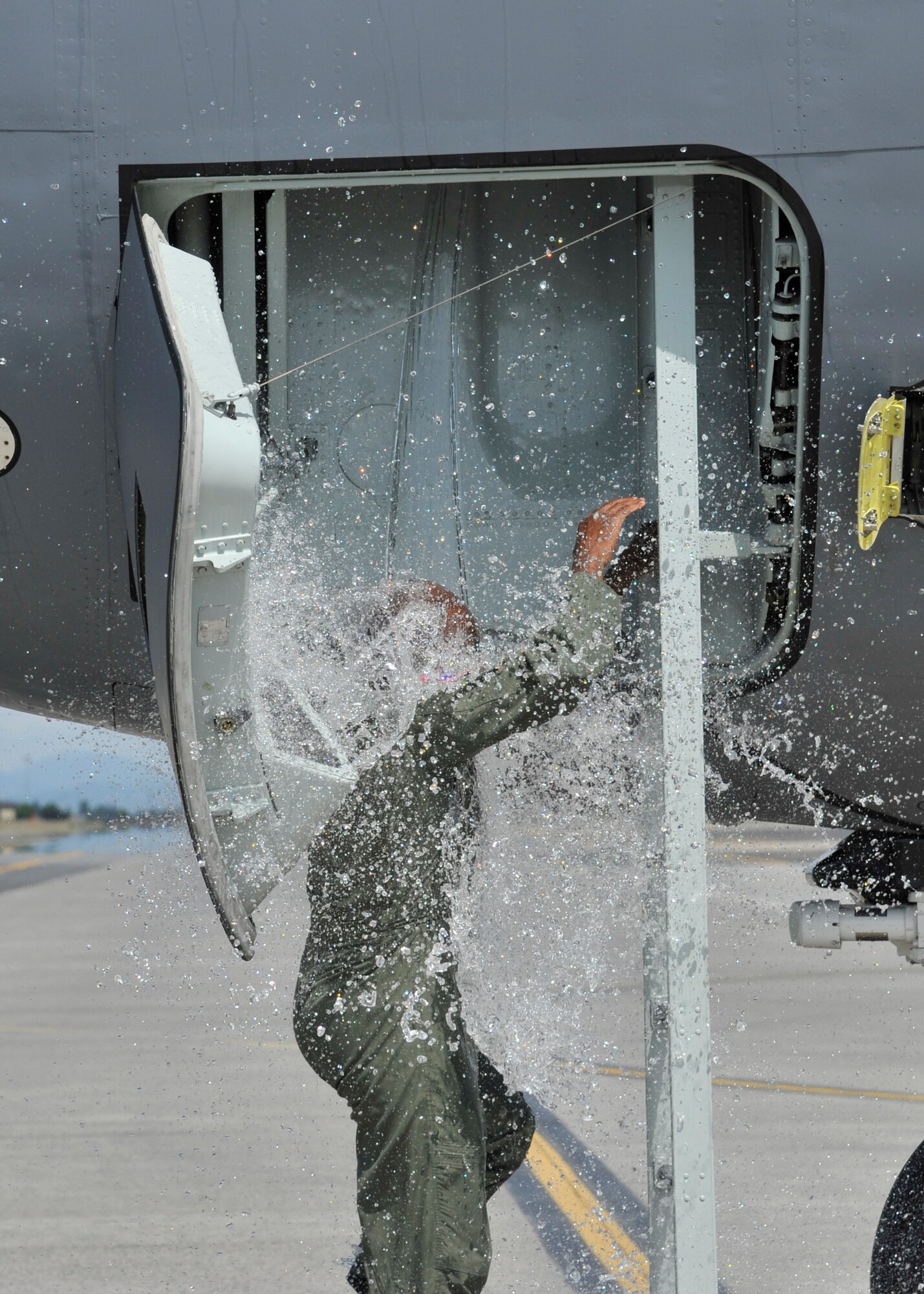Col. Brian Hill, 92nd Air Refueling Wing vice commander, gets a bucket of water dumped on him while exiting a KC-135 Stratotanker upon completion of his final flight May 29, 2015, at Fairchild Air Force Base, Wash. Over the years, Hill accumulated more than 3,000 flight hours flying both the C-130 Hercules and KC-135. (U.S. Air Force photo/Airman 1st Class Taylor Bourgeous)