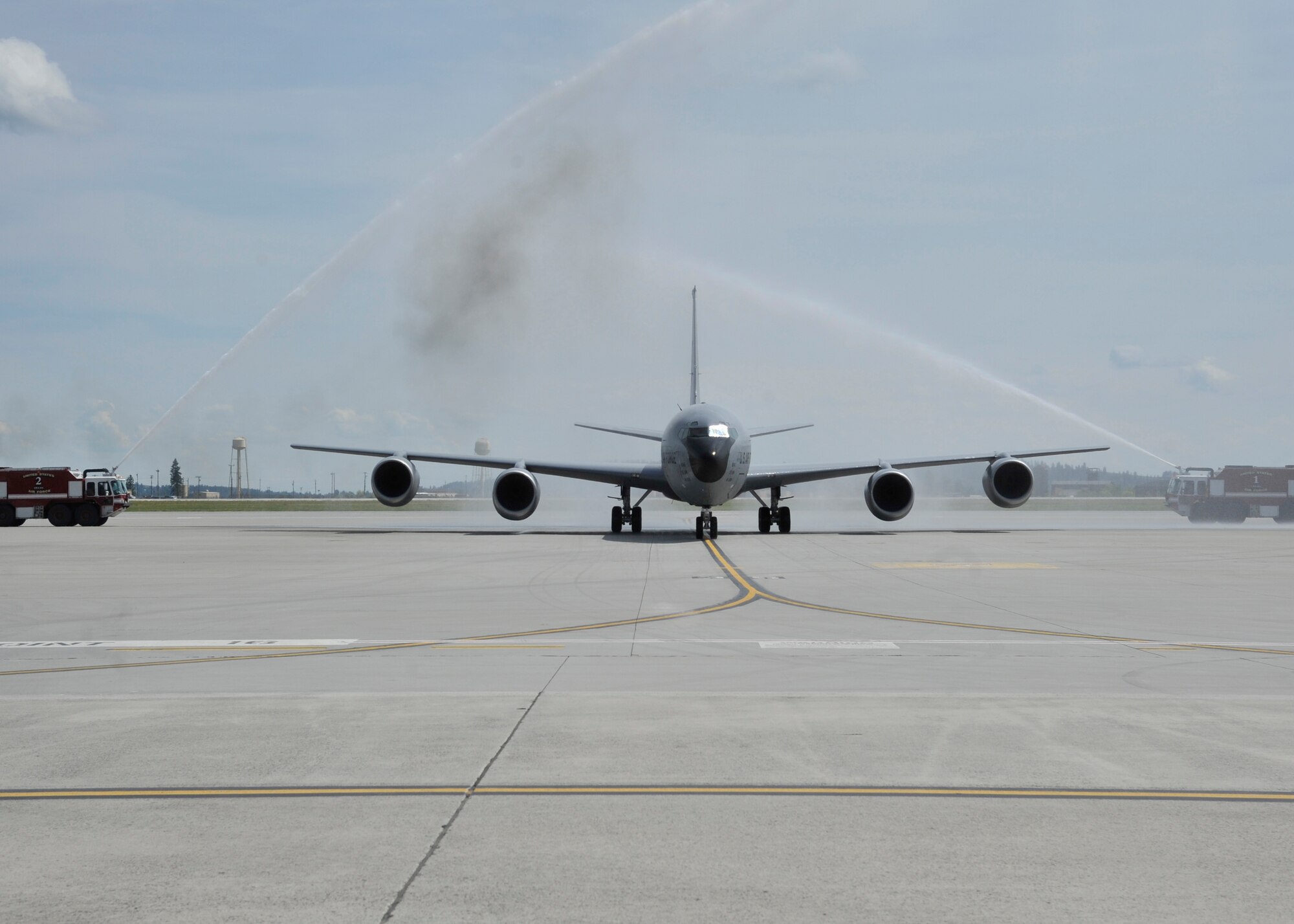 A KC-135 Stratotanker, piloted by Col. Brian Hill, 92nd Air Refueling Wing vice commander, taxis through an archway of water May 29, 2015, upon completion of Hill final flight at Fairchild Air Force Base, Wash. The final flight is an aviation tradition in which aircrew members, upon completion of their last flight with the wing, or "fini flight," are met and hosed down with water by their unit comrades, family and friends. (U.S. Air Force photo/Airman 1st Class Taylor Bourgeous)