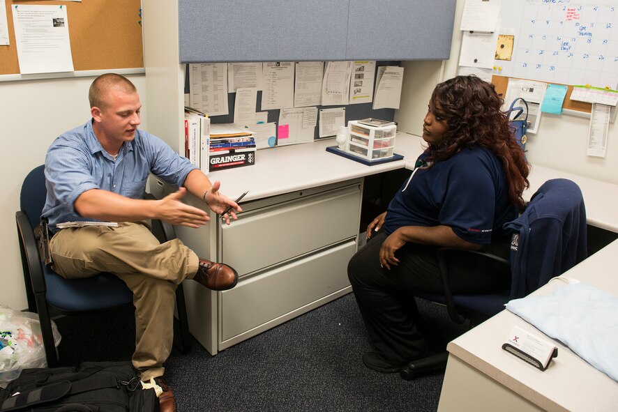 Inspector William Terpestra, 23d Security Forces Squadron, questions witness Kresynce Fraizer, Exchange customer service supervisor, during an anti-robbery exercise June 1, 2015, at Moody Air Force Base, Ga. Fraizer played the role of a cashier who was given the robbery note. (U.S. Air Force photo by Airman 1st Class Ceaira Tinsley/Released)
