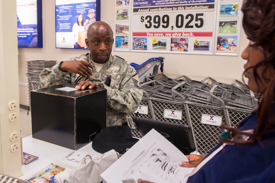 U.S. Air Force Master Sgt. Timothy Flagg, 23d Security Forces Squadron flight chief, questions a witness during an anti-robbery exercise at the Exchange June 1, 2015, at Moody Air Force Base, Ga. Flagg responded to a 911 call reporting a robbery at the Exchange and was the first on-scene. (U.S. Air Force photo by Airman 1st Class Ceaira Tinsley/Released)