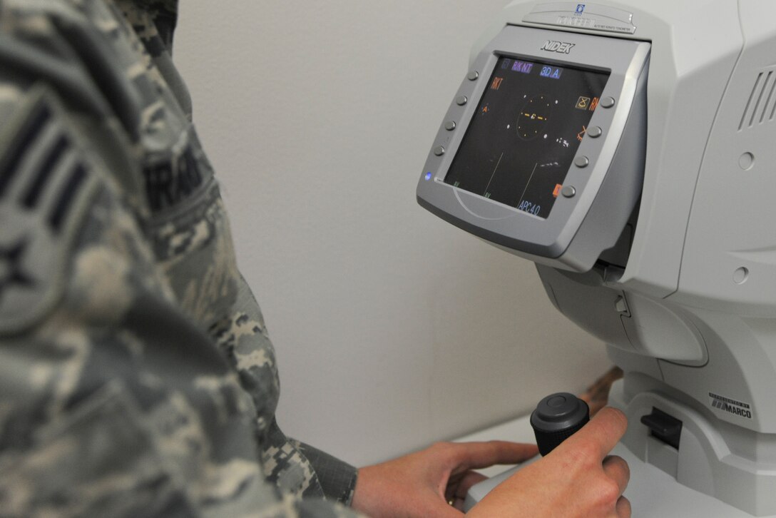 Senior Airman Katherine Girard, 779th Aerospace Medical Service optometry technician, operates an autorefractor at the Optometry Clinic on Joint Base Andrews, Md., June 2, 2015. The autorefractor tests with non-contact tonometry, which measures eye prescriptions and pressure. (U.S. Air Force photo/ Airman 1st Class J.D. Maidens)
