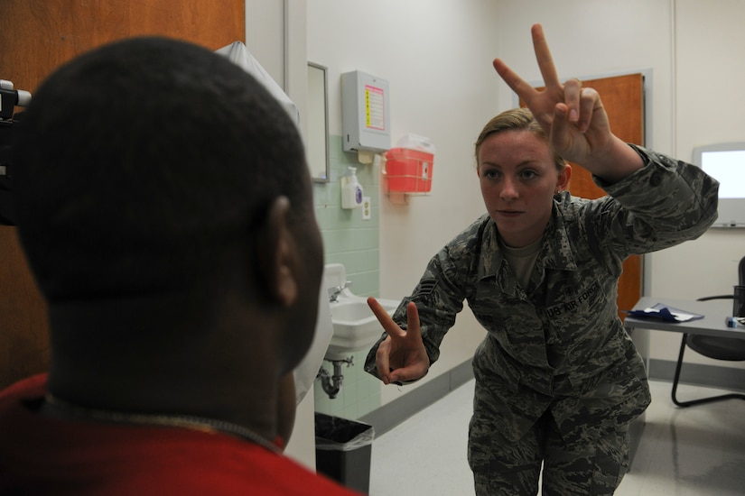 Senior Airman Katherine Girard, 779th Aerospace Medical Service optometry technician, performs a Fields test on Maj. Charles Jones, National Guard Bureau logistical support officer, at the Optometry Clinic on Joint Base Andrews, Md., June 2, 2015. The Fields test tests peripheral vision. (U.S. Air Force photo/ Airman 1st Class J.D. Maidens)