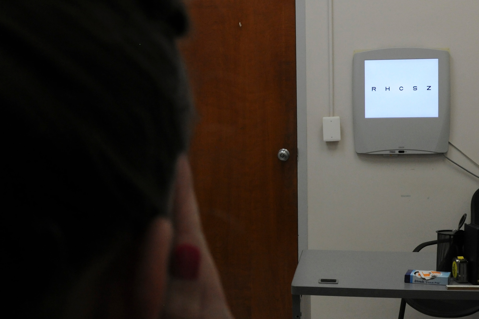 Olivia Morris, a Flight Medicine nurse, takes a Distance Visual Acuity Test at the Optometry Clinic on Joint Base Andrews, Md., June 6, 2015. The test measures eyesight at various distances. (U.S. Air Force photo/ Airman 1st Class J.D. Maidens)