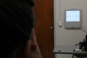Olivia Morris, a Flight Medicine nurse, takes a Distance Visual Acuity Test at the Optometry Clinic on Joint Base Andrews, Md., June 6, 2015. The test measures eyesight at various distances. (U.S. Air Force photo/ Airman 1st Class J.D. Maidens)