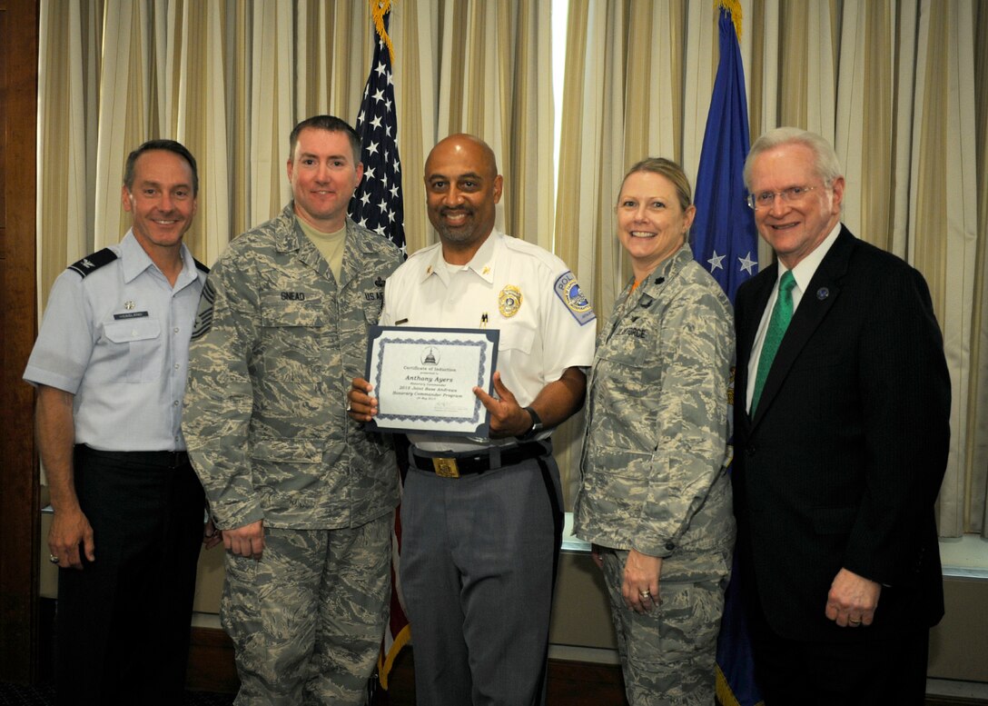 Anthony Ayers, center, Capitol Heights Police Department chief, receives a certificate from Lt. Col. Pamela Zane, second from right, 744th Communication Squadron commander; Chief Master Sgt. Thomas Snead, second from left 844th Communication Group chief enlisted manager; Col. Bradley Hoagland, far left, 11th Wing/Joint Base Andrews commander; and Jim Estepp, far right, Andrews Business & Community Alliance president and chief executive officer and Senior Andrews Ambassador, May 29, 2015, at The Club, Joint Base Andrews, Md. The Joint Base Andrews Honorary Commander Program encourages an exchange of ideas and experiences, as well as partnerships between key leaders of the base's surrounding communities, JBA commanders and Airmen.  (U.S.  Air Force photo by Senior Airman Preston Webb/RELEASED)