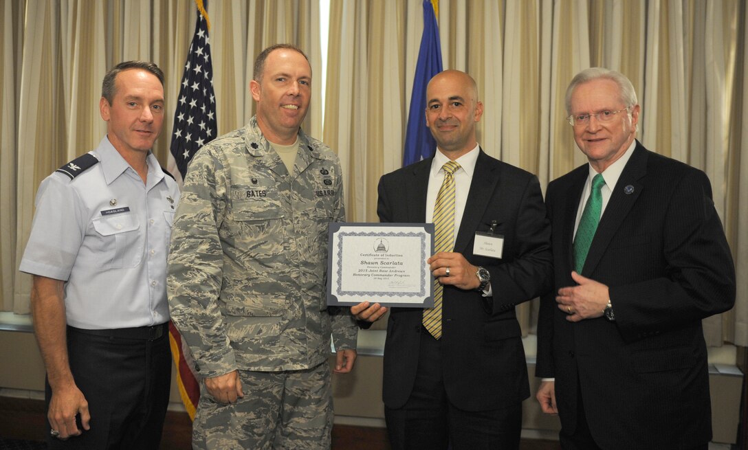 Shawn Scarlata, center right, Blueline Security Services owner and chief executive officer, receives a certificate from Lt. Col. Patrick Gates, center left, 11th Contracting Services Squadron commander; Col. Bradley Hoagland, far left, 11th Wing/Joint Base Andrews commander; and Jim Estepp, far right, Andrews Business & Community Alliance president and chief executive officer and Senior Andrews Ambassador, May 29, 2015, at The Club, Joint Base Andrews, Md. The Joint Base Andrews Honorary Commander Program encourages an exchange of ideas and experiences, as well as partnerships between key leaders of the base's surrounding communities, JBA commanders and Airmen.  (U.S.  Air Force photo by Senior Airman Preston Webb/RELEASED)