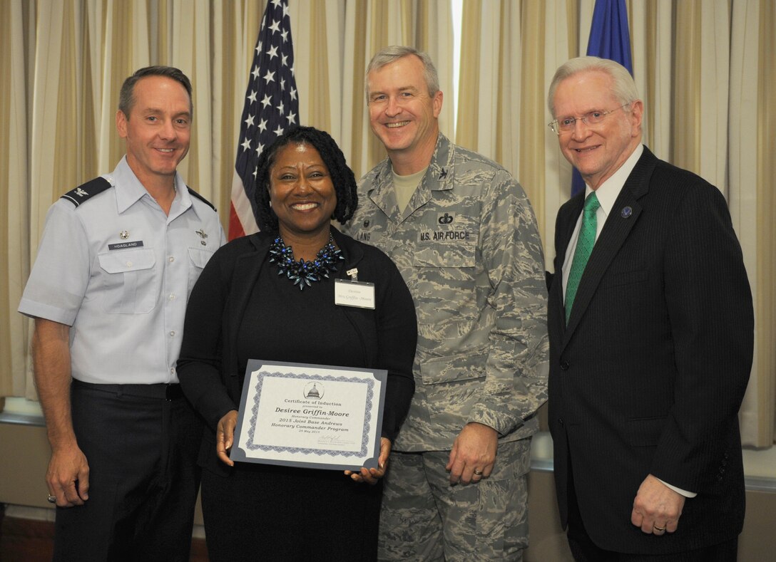 Desiree Griffin-Moore, center left, The Community Foundation in Prince George’s County executive director, receives a certificate from Col. Larry Lang, center right, United States Air Force Band commander; Col. Bradley Hoagland, far left, 11th Wing/Joint Base Andrews commander; and Jim Estepp, far right, Andrews Business & Community Alliance president and chief executive officer and Senior Andrews Ambassador, May 29, 2015, at The Club, Joint Base Andrews, Md. The Joint Base Andrews Honorary Commander Program encourages an exchange of ideas and experiences, as well as partnerships between key leaders of the base's surrounding communities, JBA commanders and Airmen.  (U.S.  Air Force photo by Senior Airman Preston Webb/RELEASED)
