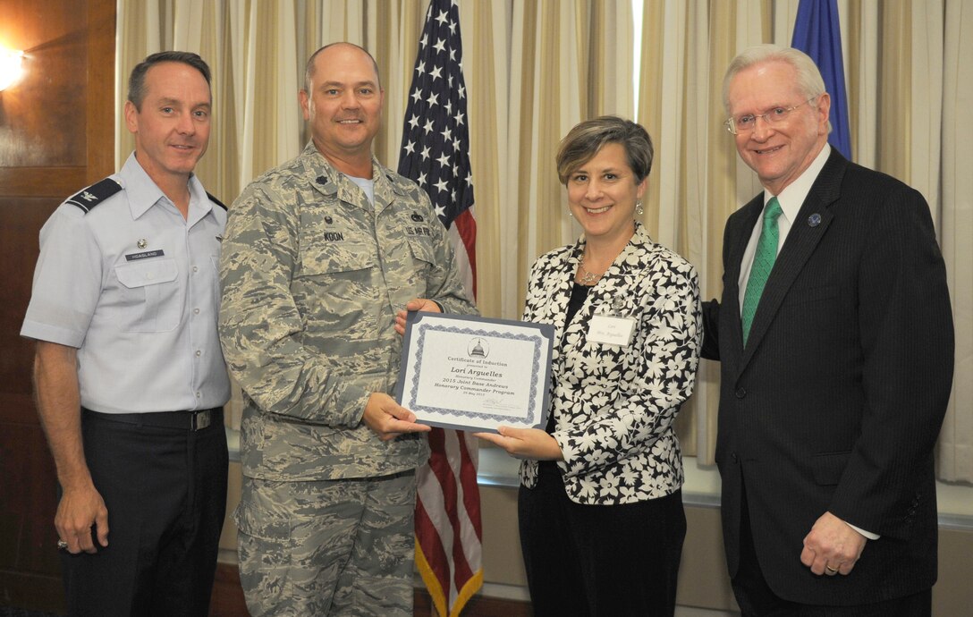 Lori Arguelles, center right, The Alice Ferguson Foundation president and chief executive officer, receives a certificate from Lt. Col. Robert Koon, center left, 11th Logisitics Readiness Squadron commander; Col. Bradley Hoagland, far left, 11th Wing/Joint Base Andrews commander; and Jim Estepp, far right, Andrews Business & Community Alliance president and chief executive officer and Senior Andrews Ambassador, May 29, 2015, at The Club, Joint Base Andrews, Md. The Joint Base Andrews Honorary Commander Program encourages an exchange of ideas and experiences, as well as partnerships between key leaders of the base's surrounding communities, JBA commanders and Airmen.  (U.S.  Air Force photo by Senior Airman Preston Webb/RELEASED)