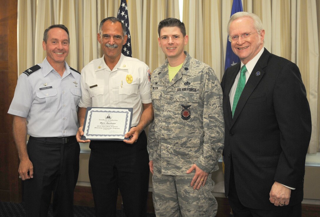 Marc Bashoor, center left, Prince George’s County fire chief, receives a certificate from Lt. Col. Rockie Wilson, center right, 11th Civil Engineering Squadron commander; Col. Bradley Hoagland, far left, 11th Wing/Joint Base Andrews commander; and Jim Estepp, far right, Andrews Business & Community Alliance president and chief executive officer and Senior Andrews Ambassador, May 29, 2015, at The Club, Joint Base Andrews, Md. The Joint Base Andrews Honorary Commander Program encourages an exchange of ideas and experiences, as well as partnerships between key leaders of the base's surrounding communities, JBA commanders and Airmen.  (U.S.  Air Force photo by Senior Airman Preston Webb/RELEASED)