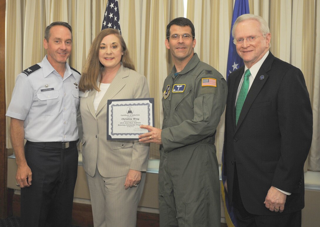 Christine Wray, center left, Medstar Southern Maryland Hospital Center president, receives a certificate from Col. Thomas Cantilina, 779th Medical Group commander; Col. Bradley Hoagland, far left, 11th Wing/Joint Base Andrews commander; and Jim Estepp, far right, Andrews Business & Community Alliance president and chief executive officer and Senior Andrews Ambassador, May 29, 2015, at The Club, Joint Base Andrews, Md. The Joint Base Andrews Honorary Commander Program encourages an exchange of ideas and experiences, as well as partnerships between key leaders of the base's surrounding communities, JBA commanders and Airmen.  (U.S.  Air Force photo by Senior Airman Preston Webb/RELEASED)