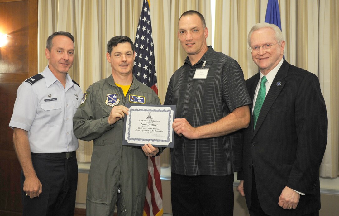 Dave Dotterer, center right, Mission BBQ director of operations, receives a certificate from Col. Larry Riddick, center left, 811th Operations Group commander; Col. Bradley Hoagland, far left, 11th Wing/Joint Base Andrews commander; and Jim Estepp, far right, Andrews Business & Community Alliance president and chief executive officer and Senior Andrews Ambassador, May 29, 2015, at The Club, Joint Base Andrews, Md. The Joint Base Andrews Honorary Commander Program encourages an exchange of ideas and experiences, as well as partnerships between key leaders of the base's surrounding communities, JBA commanders and Airmen.  (U.S.  Air Force photo by Senior Airman Preston Webb/RELEASED)
