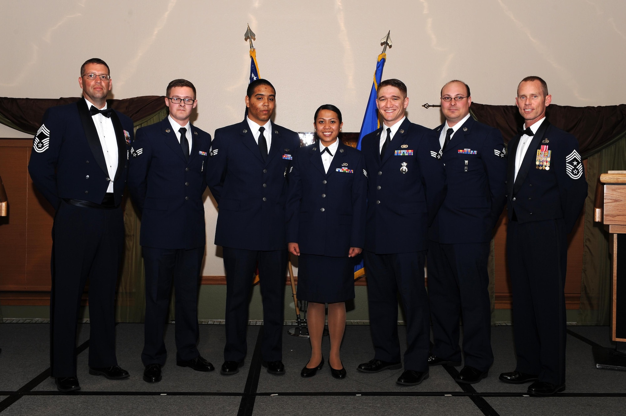 The Airman Leadership School Class 15-D graduated with 48 students during a ceremony held at the Jimmy Doolittle Center at Minot Air Force base, May 28, 2015. Congratulations to the graduates and special recognition to the following award winners: Commandant's Award: Senior Airman Benjamin Johnson, 91st Security Support Squadron; Academic Achievement Award: Senior Airman Connor Gurule, 5th Security Forces Squadron; Distinguished Graduate Awards: Senior Airman Connor Gurule 5th SFS, Senior Airman Benjamin Johnson 91st SSPTS, Senior Airman Robert Pruim 91st Operations Support Squadron, Senior Airman Hollykris Vergara, 5th Civil Engineer Squadron; John L. Levitow Award: Senior Airman Matthew Newton 91st OSS. Pictured here from left to right are: Chief Master Sgt. David Richard, 5th Maintenance Group wing weapons manager, Senior Airmen Matthew Newton, Connor Gurule, Hollykris Vergara, Benjamin Johnson, Robert Pruim and Chief Master Sgt. Geoff Weimer, 5th Bomb Wing command chief. (U.S. Air Force photo/Senior Airman Kristoffer Kaubisch)