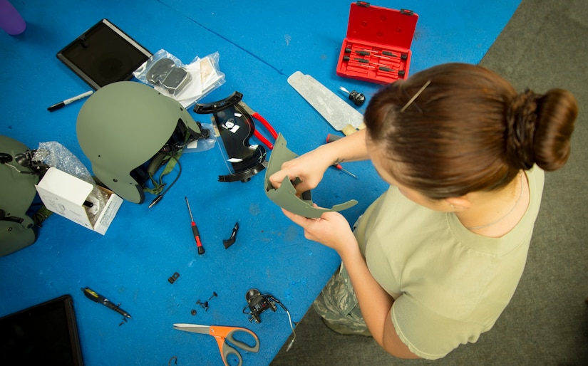 Airman 1st Class Lacey McGee, 811th Operations Support Squadron aircrew flight equipment technician, assembles a visor for an HGU-56/P helmet on Joint Base Andrews Md., May 26, 2015. Helmets undergo an inspection every 90 days to ensure they remain safe and operable.  (U.S. Air Force photo/Airman 1st Class Ryan J. Sonnier)