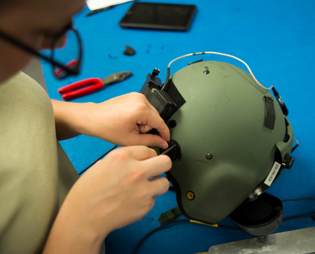 Airman 1st Class Lacey McGee, 811th Operations Support Squadron aircrew flight equipment technician, replaces parts on an HGU-56/P helmet on Joint Base Andrews, Md., May 26, 2015. Helmets undergo an inspection every 90 days to ensure they remain safe and operable. (U.S. Air Force photo/Airman 1st Class Ryan J. Sonnier)