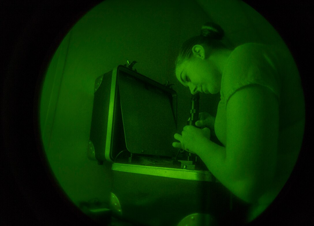 Airman 1st Class Lacey McGee, 811th Operations Support Squadron aircrew flight equipment technician, tests night vision goggles on Joint Base Andrews, Md., May 26, 2015. This 180-day inspection ensures they are operable and free from spots in the field of view. (U.S. Air Force photo/Airman 1st Class Ryan J. Sonnier)