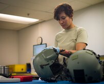 Staff Sgt. Jennifer Francis, 811th Operations Support Squadron aircrew flight equipment technician, cleans an HGU-56/P helmet on Joint Base Andrews, Md., May 26, 2015. Helmets are inspected every 90-days to ensure they are safe and in good condition. (U.S. Air Force photo/Airman 1st Class Ryan J. Sonnier)