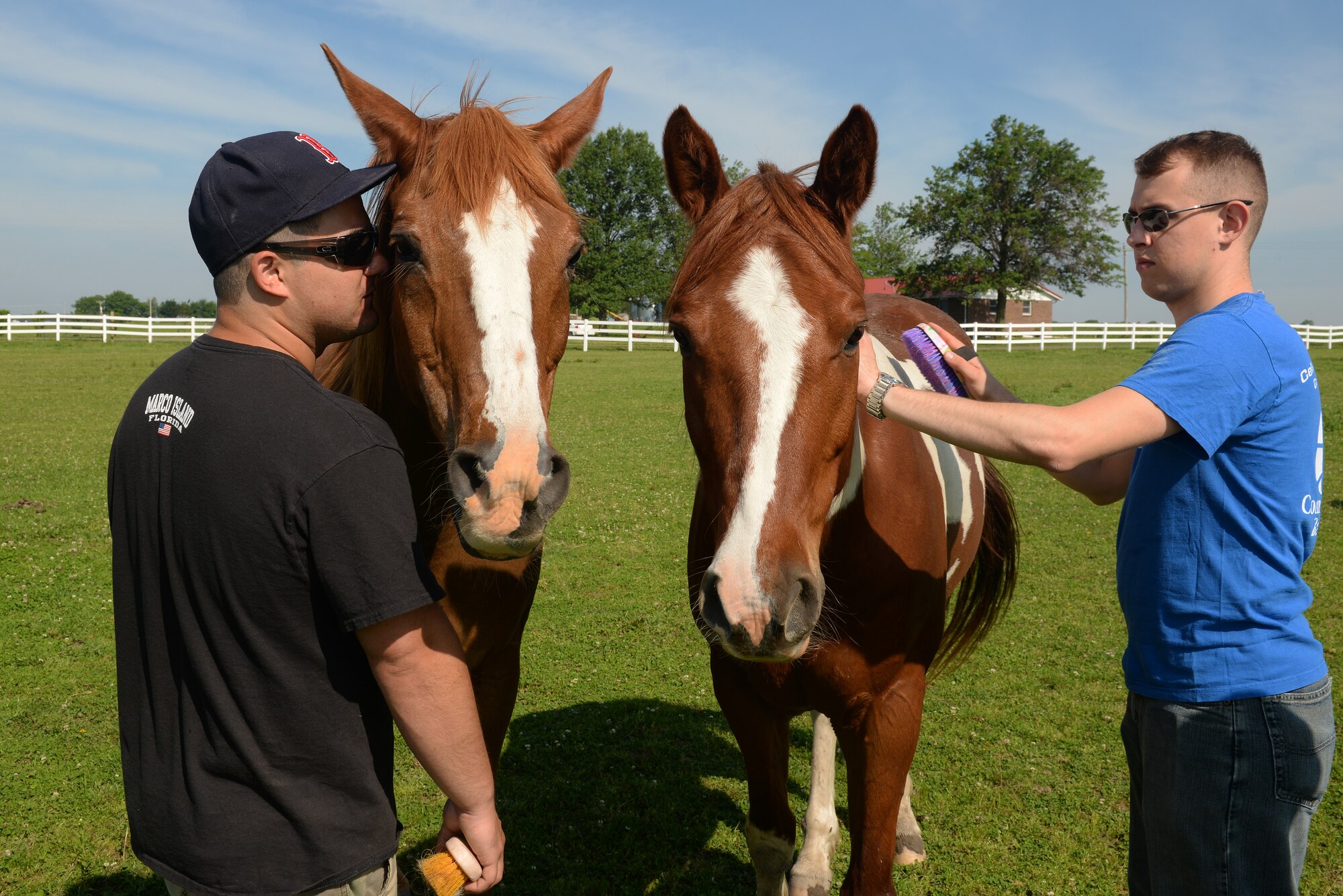 Senior Airmen Joshua Rose and Anthony Carmignani, 375th Operations Support Squadron Air Traffic Controllers, brush Cherokee and Jasper, two of the nine horses at Chakota, a therapeutic horseback riding center, Germantown, Illinois, May 28, 2015. Rose has volunteered at Chakota before, bringing a group of Airmen with him to enhance the facility. This is one of the several instances where he rallies volunteer groups to make a bigger impact on community projects. (U.S. Air Force photo by Airman 1st Class Erica Holbert-Siebert)