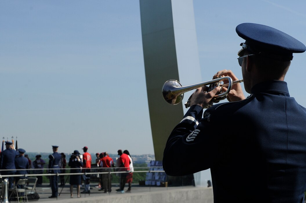 Tech. Sgt. Nathan Clark, U.S. Air Force Band ceremonial brass member, plays taps at the end of the Memorial Day wreath laying ceremony at the Air Force Memorial, May 25, 2015. Americans around the world continued the tradition of honoring fallen heroes through a wreath laying ceremony, parade or flag folding. (U.S. Air Force photo/Senior Airman Hailey Haux)