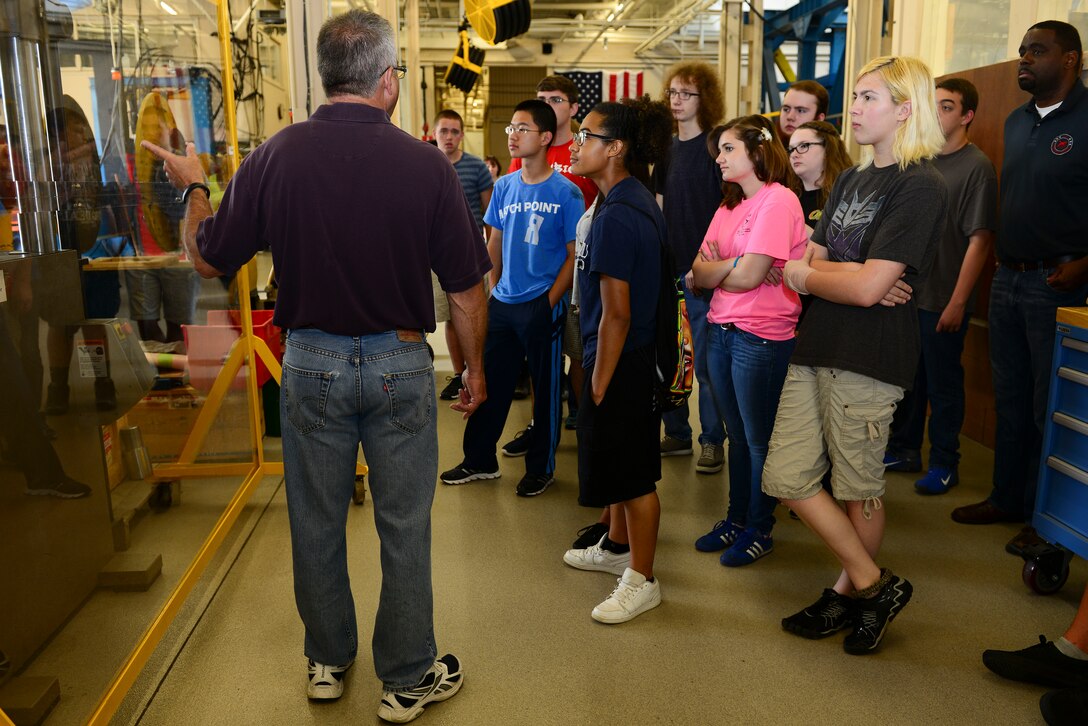 Dr. Marc Portanova, Aviation Applied Technology Directorate Aerospace Engineer team lead, conducts compression tests during a mission orientation day at Fort Eustis, Va., May 29, 2015. During the compression test, the machine compressed a soda can to its flattest level possible. (U.S. Air Force photo by Senior Airman Kimberly Nagle/Released)  