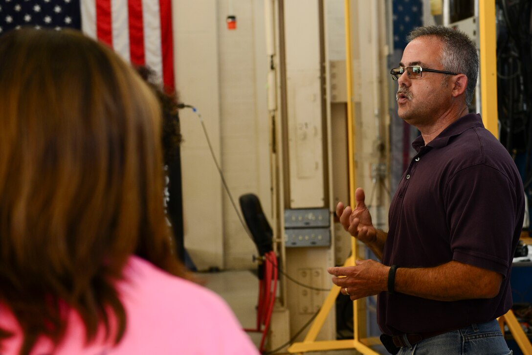 Dr. Marc Portanova, Aviation Applied Technology Directorate Aerospace Engineer team lead, speaks to local high school students during a mission orientation day at Fort Eustis, Va., May 29, 2015. While at the AATD, the students observed a tension and compression test of different objects such as a soda can. (U.S. Air Force photo by Senior Airman Kimberly Nagle/Released)  