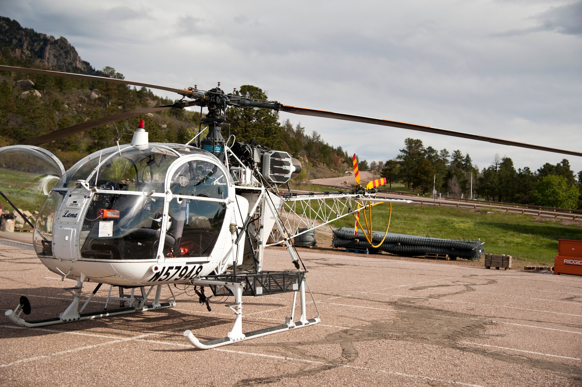 CHEYENNE MOUNTAIN AIR FORCE STATION, Colorado – A “Lama” helicopter designed for high elevation prepares to lift equipment in and out of the canyons where ring nets are being installed, May, 28, 2015. The five ring nets are one of four steps in the mitigation process to reduce the damage of future landslides. The ring nets, 15-foot deep main catchment basin, a culvert down the mountain into the storm water system and infrastructure protection are being built as a result of landslides that struck the mountain Sept. 12, 2013, following torrential rain. (U.S. Air Force photo by Senior Airman Tiffany DeNault)