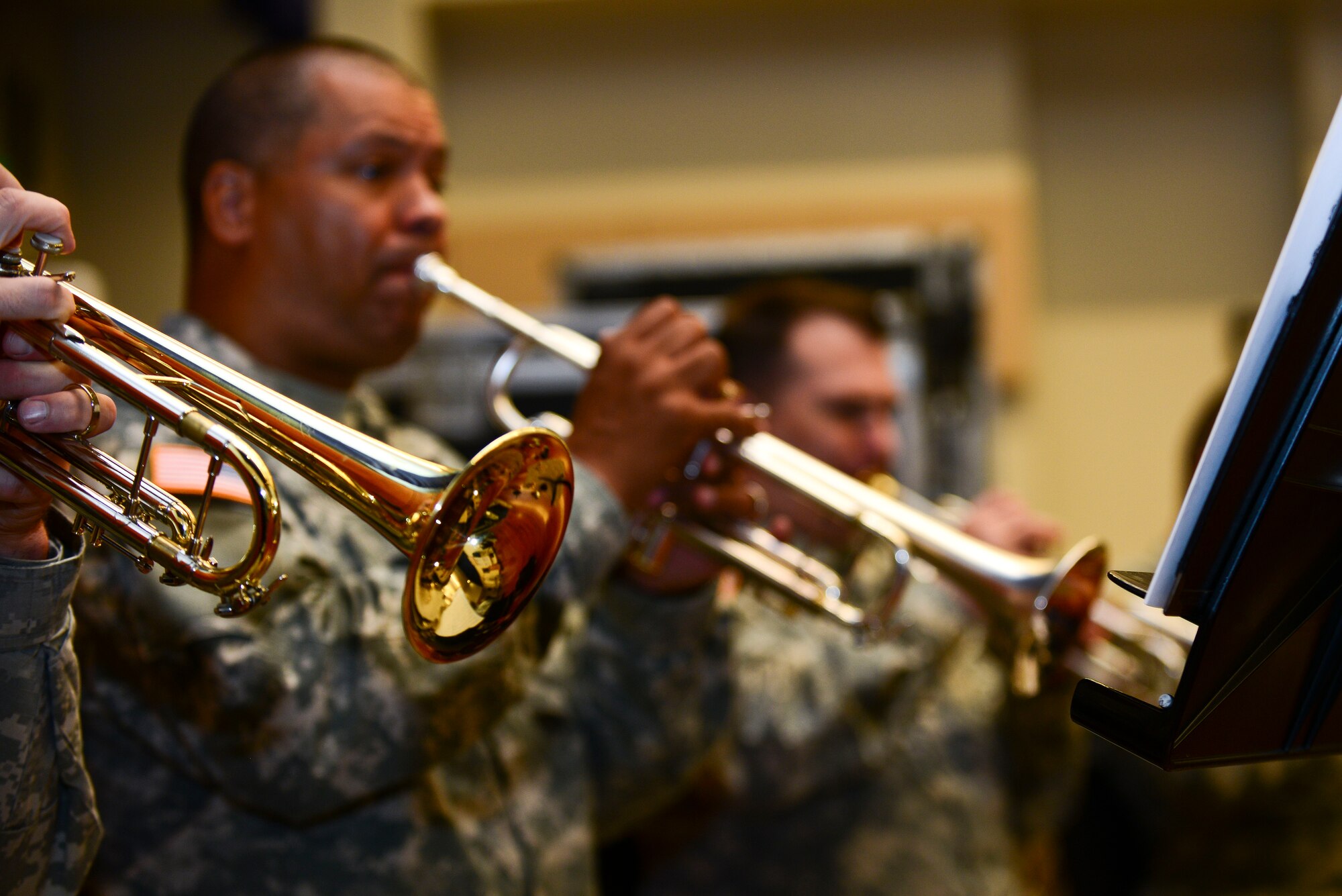 The U.S. Army Training Doctrine and Command Band concert band trumpet section performs during a rehearsal at Fort Eustis, Va., June 1, 2015. During rehearsal, different sections of the band repeated playing the same spot of music to ensure precision for their summer concert series, “Music Under the Stars.”   (U.S. Air Force photo by Senior Airman Kimberly Nagle/Released)  