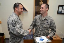 Master Sgt. Nicholas Souza (left), 66th Comptroller Squadron and 66th Air Base Group Staff Agency first sergeant, congratulates Tech Sgt. Jeremy Walter, 66th Air Base Group training NCO in charge, on being named a Diamond Sharp Award recipient June 2. The Hanscom first sergeants selected Walter as the recipient for performance reflecting the highest standard of professionalism and pride. The Diamond Sharp program, adopted by the First Sergeant Council, aims to recognize the base’s sharpest personnel in the grades of airman basic through technical sergeant. (U.S. Air Force photo by Jerry Saslav)