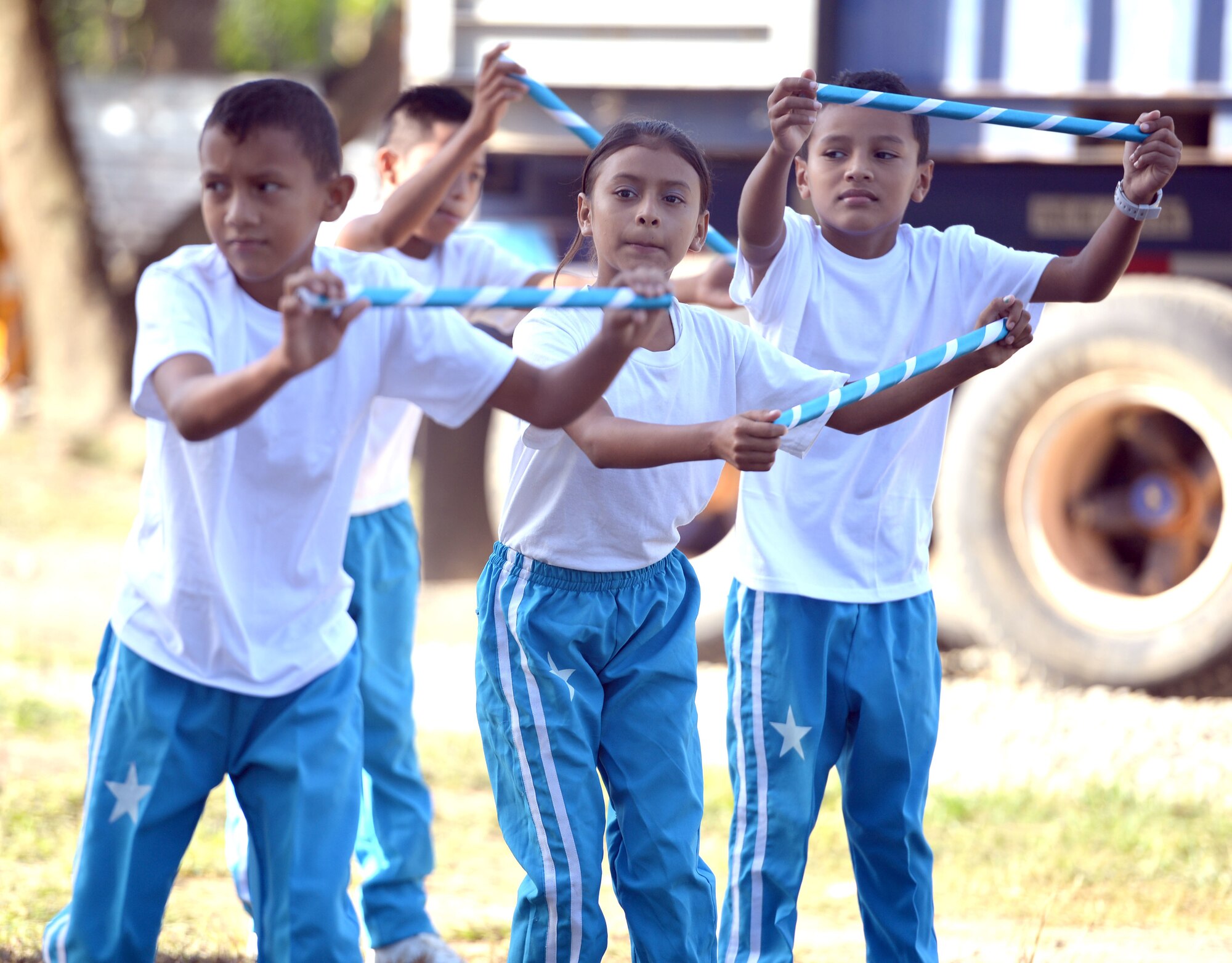 Gabriela Mistral students perform a a modern dance number for the attendees of the groundbreaking ceremony at the school in Ocotoes Alto, Honduras, June 1, 2015. The event also marked the beginning of the New Horizons Honduras 2015 training exercise. New Horizons was launched in the 1980s and is an annual joint humanitarian assistance exercise that U.S. Southern Command conducts with a partner nation in Central America, South America or the Caribbean. The exercise improves joint training readiness of U.S. and partner nation civil engineers, medical professionals and support personnel through humanitarian assistance activities. (U.S. Air Force photo by Capt. David J. Murphy/Released)