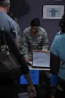 Senior Airman Jennifer Zimmerman of the 919th Special Operations Force Support Squadron, checks paperwork for veterans arriving at Duke Field's Individual Ready Reserve muster recently. The squadron led the way in processing more than 130 IRR Airmen through a variety of stations to ensure their readiness to mobilize in the event of a national emergency. (U.S. Air Force photo/Dan Neely)