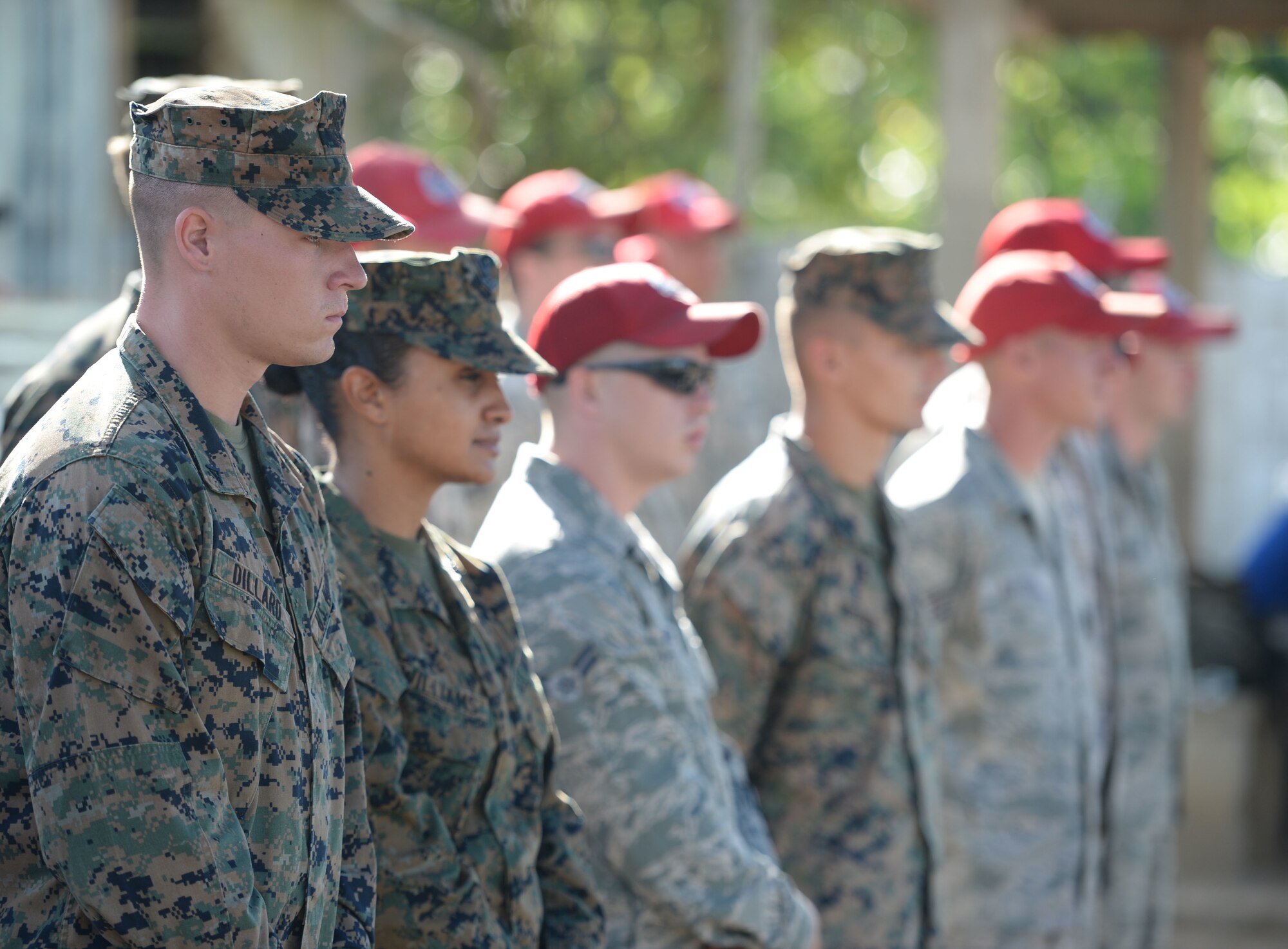 U.S. Air Force Airmen from the 823rd Expeditionary RED HORSE Squadron, out of Hurlburt Field, Fla., and U.S. Marines from the 271st Marine Wing Support Squadron, 2nd Marine Air Wing, out of Marine Corps Air Station Cherry Point, N.C., watch the groundbreaking ceremony at the Gabriela Mistral school in Ocotoes Alto, Honduras, June 1, 2015. The Airmen and Marines will be working together as part of the New Horizons Honduras 2015 training exercise, an annual humanitarian exercise put on by U.S. Southern Command. New Horizons was launched in the 1980s and is an annual joint humanitarian assistance exercise that U.S. Southern Command conducts with a partner nation in Central America, South America or the Caribbean. The exercise improves joint training readiness of U.S. and partner nation civil engineers, medical professionals and support personnel through humanitarian assistance activities. (U.S. Air Force photo by Capt. David J. Murphy/Released)