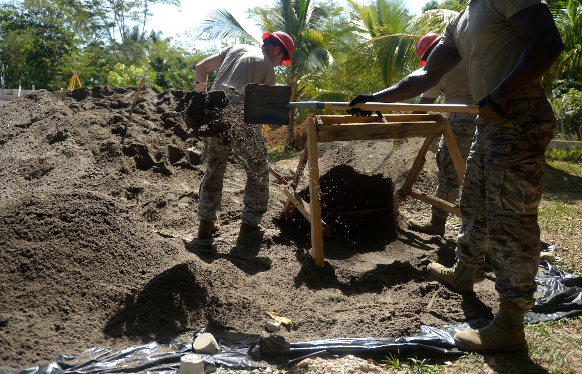 Members of the 823rd Expeditionary RED HORSE Squadron use a screen to sift through dirt, which will be used to create mortar for the bricks used in the creation of the new building at the Gabriela Mistral school in Ocotoes Alto, Honduras, June 1, 2015. The RED HORSE members are in Honduras to participate in a New Horizons training exercise taking place throughout Trujillo and Tocoa. New Horizons was launched in the 1980s and is an annual joint humanitarian assistance exercise that U.S. Southern Command conducts with a partner nation in Central America, South America or the Caribbean. The exercise improves joint training readiness of U.S. and partner nation civil engineers, medical professionals and support personnel through humanitarian assistance activities. (U.S. Air Force photo by Capt. David J. Murphy/Released)