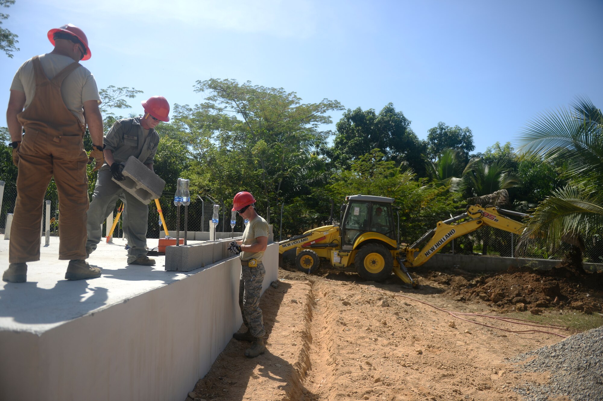 U.S. Air Force Airmen with the 823rd Expeditionary RED HORSE Squadron out of Hurlburt Field, Fla., prepare the first layer of brick, or the first course, in the construction of a new two-classroom building at the Gabriela Mistrel primary school in Ocotoes Alto, Honduras, June 1, 2015. New Horizons was launched in the 1980s and is an annual joint humanitarian assistance exercise that U.S. Southern Command conducts with a partner nation in Central America, South America or the Caribbean. The exercise improves joint training readiness of U.S. and partner nation civil engineers, medical professionals and support personnel through humanitarian assistance activities. (U.S. Air Force photo by Capt. David J. Murphy/Released)