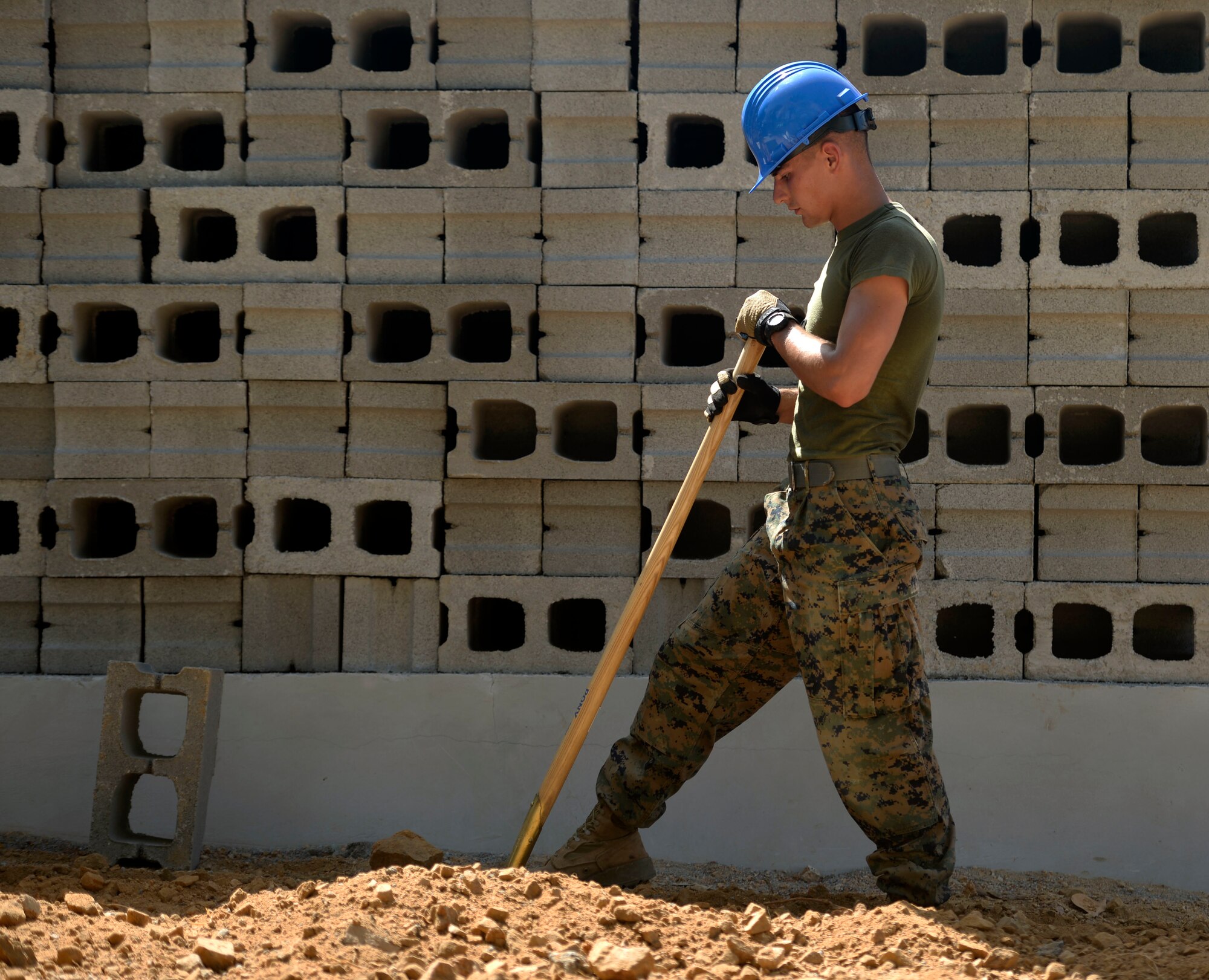 U.S. Marine Corporal Benjamin Moonen, a combat engineer with a 271st Marine Wing Support Squadron, 2nd Marine Air Wing, out of Marine Corps Air Station Cherry Point, N.C., and Sturgeon Lake, Minn. native, helps dig a trench for electrical wire during construction at the Gabriela Mistral primary school in Ocotoes Alto, Honduras, June 1, 2015. The school project is one part of the New Horizons Honduras 2015, an annual humanitarian and training exercise put on by U.S. Southern Command. New Horizons was launched in the 1980s and is an annual joint humanitarian assistance exercise that U.S. Southern Command conducts with a partner nation in Central America, South America or the Caribbean. The exercise improves joint training readiness of U.S. and partner nation civil engineers, medical professionals and support personnel through humanitarian assistance activities. (U.S. Air Force photo by Capt. David J. Murphy/Released)