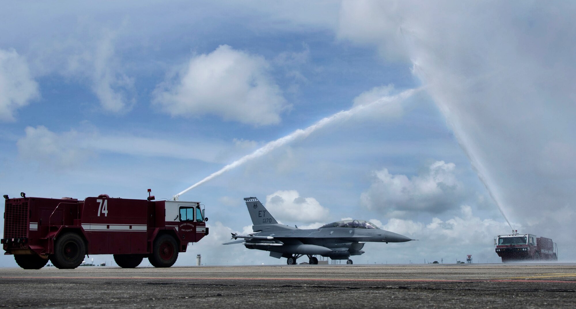 Brig. Gen. David Harris, 96th Test Wing commander, crosses through a stream of water from the base fire department in an F-16 Fighting Falcon after his fini flight May 27th at Eglin Air Force Base, Fla. The fini flight is a ceremony that symbolizes a members final flight in the unit and/or base.  Harris leaves Eglin June 4 to take command of the Air Force Test Center.  (U.S. Air Force photo/Staff Sgt. Anthony Gamez)
