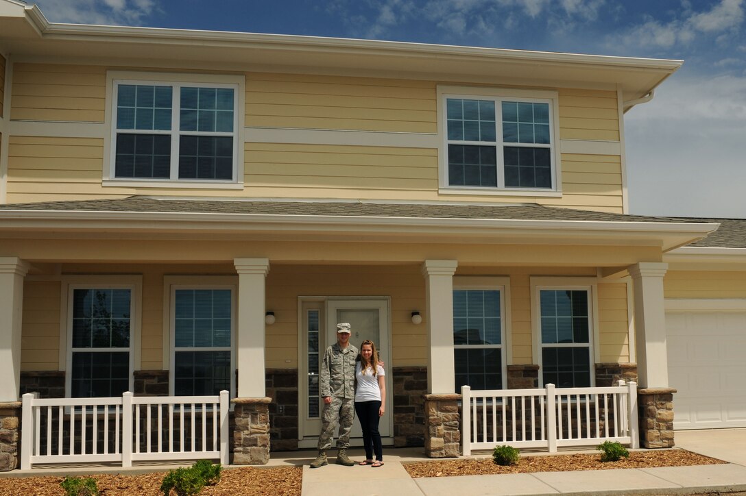 Senior Airman Dustin Monti, 28th Medical Operations Squadron bioenvironmental engineering technician, and his spouse, Beth, are the first family to move into the newest privatized housing development at Ellsworth Air Force Base, S.D., May 27, 2015. Families will begin moving into the new housing area starting June 1 through November, with 142 additional units available for occupancy. (U.S. Air Force photo by Senior Airman Hailey R. Staker/Released)