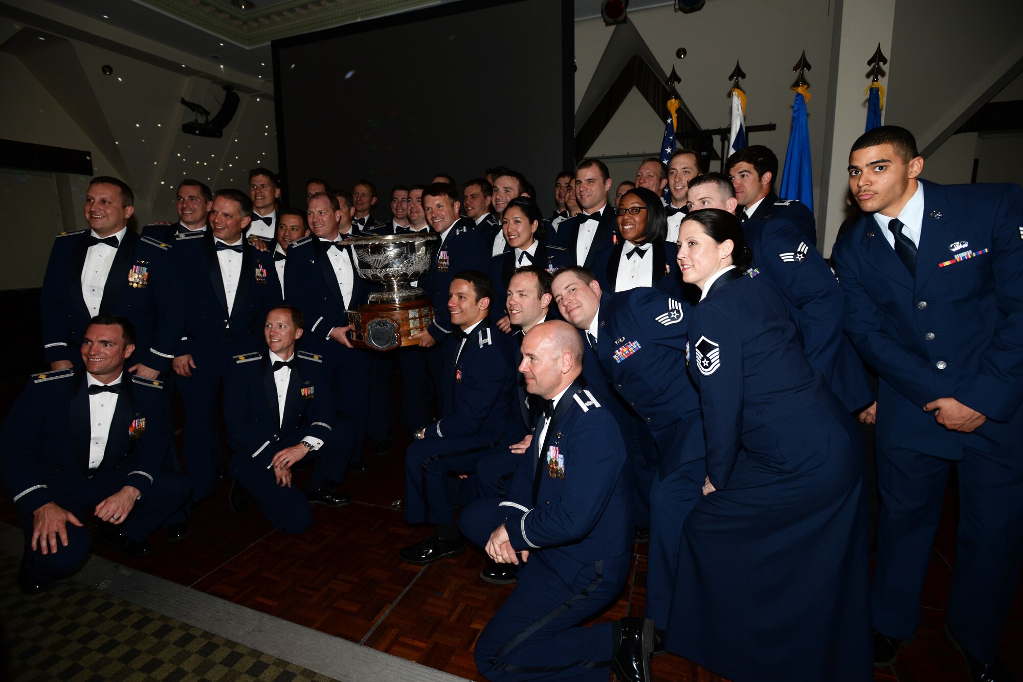 Lt. Col. John Stratton, 493rd Fighter Squadron commander, left, and Lt. Col. Lendy Renegar, former 493rd FS commander and current U.S. Air Forces in Europe and Air Forces Africa Commander's Action Group chief, hold the 2014 Raytheon Trophy during a celebration May 29, 2015. Both Stratton and Renegar served as commander of the squadron during the award period. The squadron demonstrated its ability to remain Forward, Ready, Now, and was named the top U.S. Air Force fighter squadron in January 2015. (U.S. Air Force photo by Tech. Sgt. Eric Burks/Released)