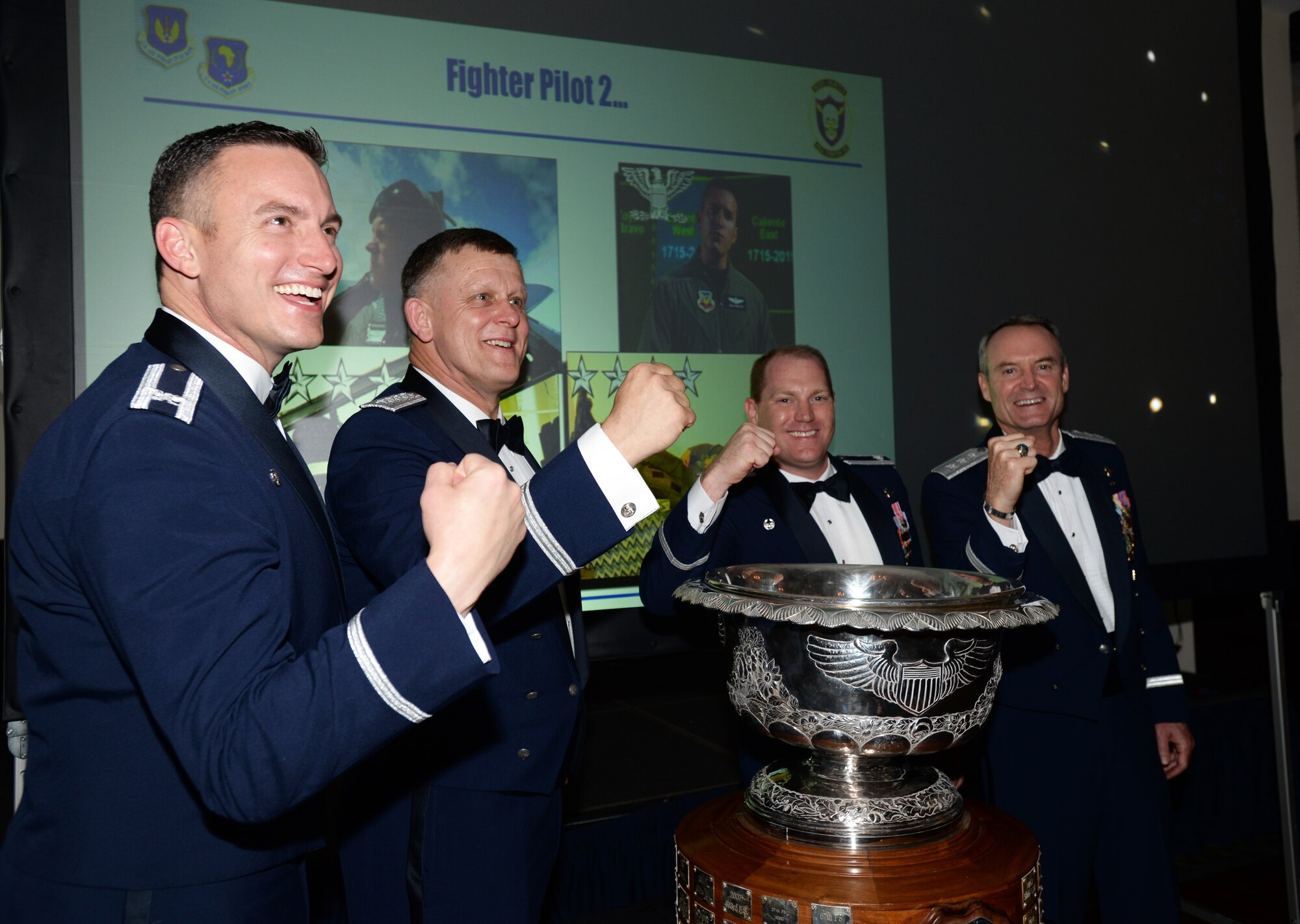 From left, Col. Robert Novotny, 48th Fighter Wing commander, Gen. Frank Gorenc, U.S. Air Forces in Europe and Air Forces Africa commander, Lt. Col. John Stratton, 493rd Fighter Squadron commander, and Lt. Gen. Darryl Roberson, 3rd Air Force and 17th Expeditionary Air Force commander, celebrate following the presentation of the 2014 Raytheon Trophy to the 493rd FS, May 29, 2015. The squadron demonstrated its ability to remain Forward, Ready, Now, and was named the top U.S. Air Force fighter squadron in January 2015. (U.S. Air Force photo by Tech. Sgt. Eric Burks/Released)