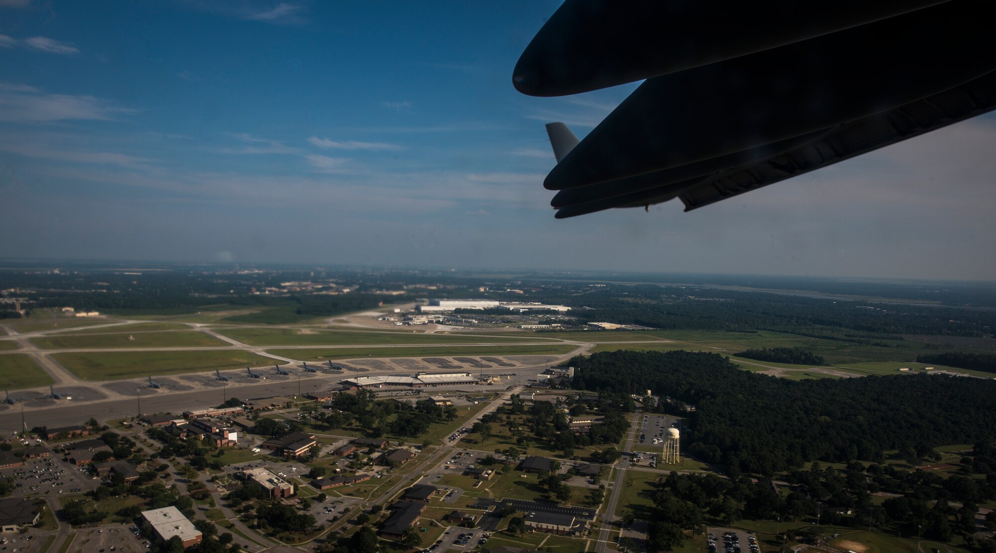 TYNDALL AIR FORCE BASE, Florida – A C-17 Globemaster III, P-223, flies over Joint Base Charleston, South Carolina. The Defense Logisics Agency Energy recently released a notice of opportunity for an energy savings performance contract at the base. The proposed scope of the ESPC includes 121 Naval Weapon Station buildings and 461 parking and streetlight fixtures. (U.S. Air Force photo/Senior Airman Dennis Sloan/Released)