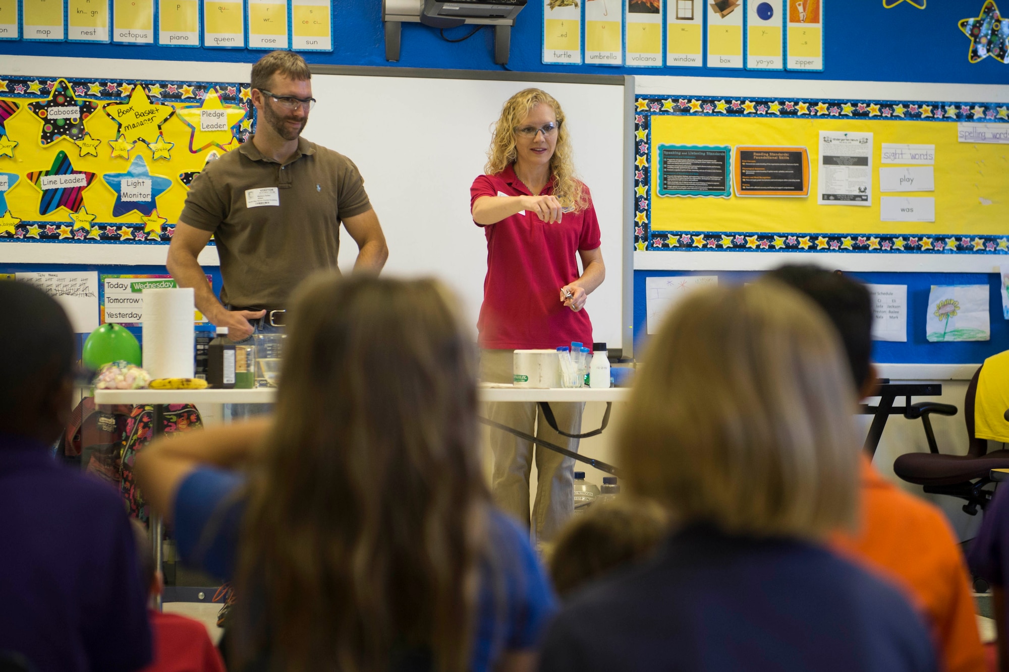 From left, Bruce Salter and Shelle McDonald, research scientists at the Air Force Civil Engineer Center at Tyndall Air Force Base, Florida, interact with kindergarten students during a science, technology, engineering and technology, or STEM, presentation at North Bay Haven Charter Academy in Panama City, Florida, May 27. The scientists performed a series of demonstrations and experiments to introduce basic concepts of physical science to the students in support of the school's Science Day. (U.S. Air Force photo/Jessica Echerri/Released)