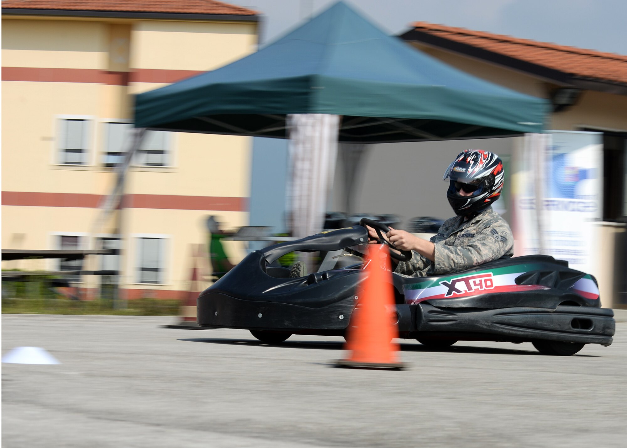 U.S. Air Force Senior Airman Michael Wychock, 31st Security Forces Squadron assistant vehicle control officer, navigates around a turn in the go-kart course, May 29, 2015, at Aviano Air Base, Italy. The go-kart course provided Airmen with the opportunity to drive a vehicle in simulated adverse road conditions. This course, along with the skid car serpentine course and a NASCAR show, started 31st Fighter Wing Safety Office’s ‘Critical Days of Summer’. (U.S. Air Force photo by Airman 1st Class Cary Smith/Released)