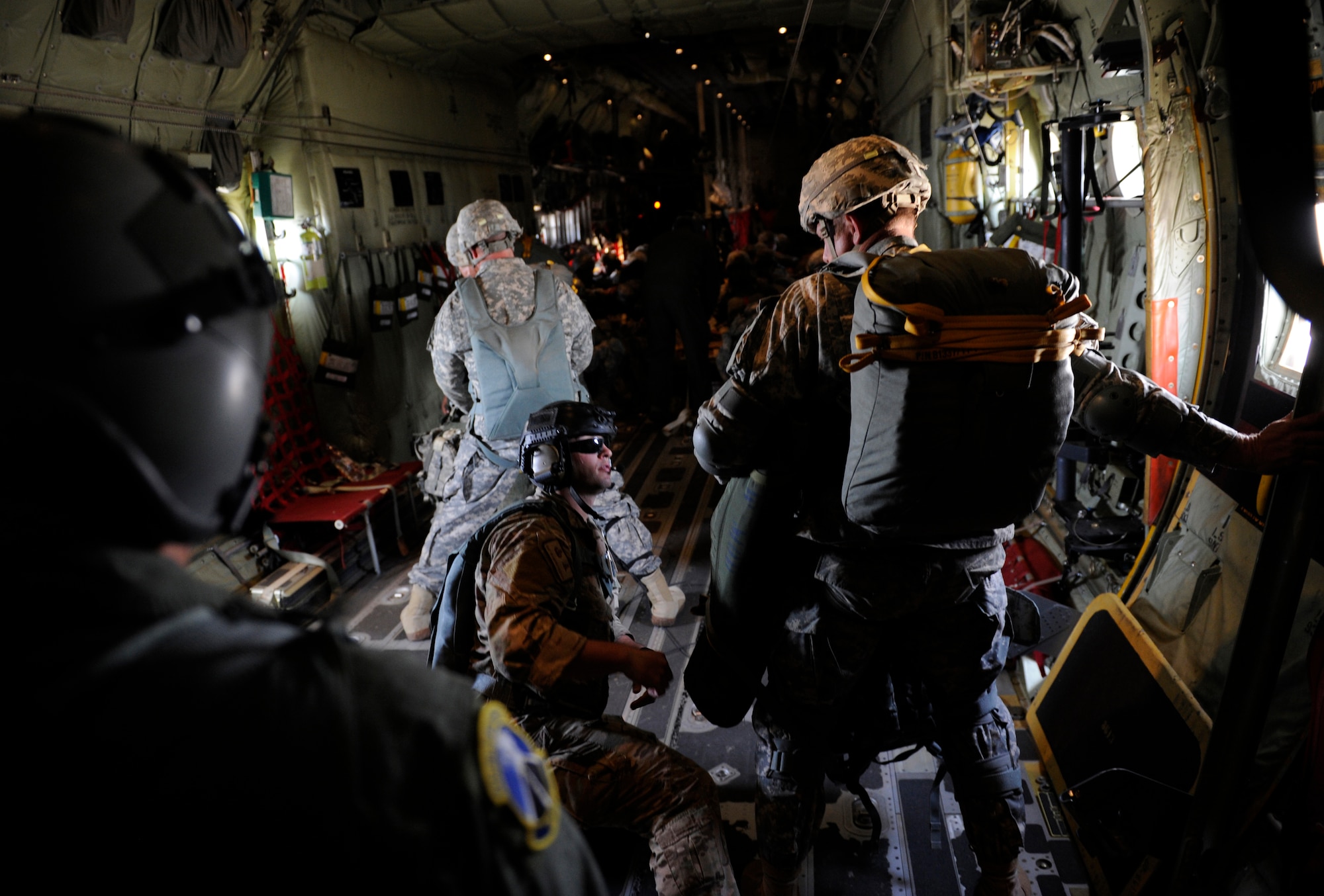 U.S. Army Staff Sgt. Brandon Fountain, center, 435th Contingency Response Group jump master out of Ramstein Air Base, Germany, preforms last minute safety duties for an airborne operation during Exercise Noble Shirley May 12, 2015, over Israel. Staff Sgt. Fountain has been a jump master since 2012 and began jumping in 2008.  (U.S. Air Force photo/Tech. Sgt. Patrick Mitchell)

