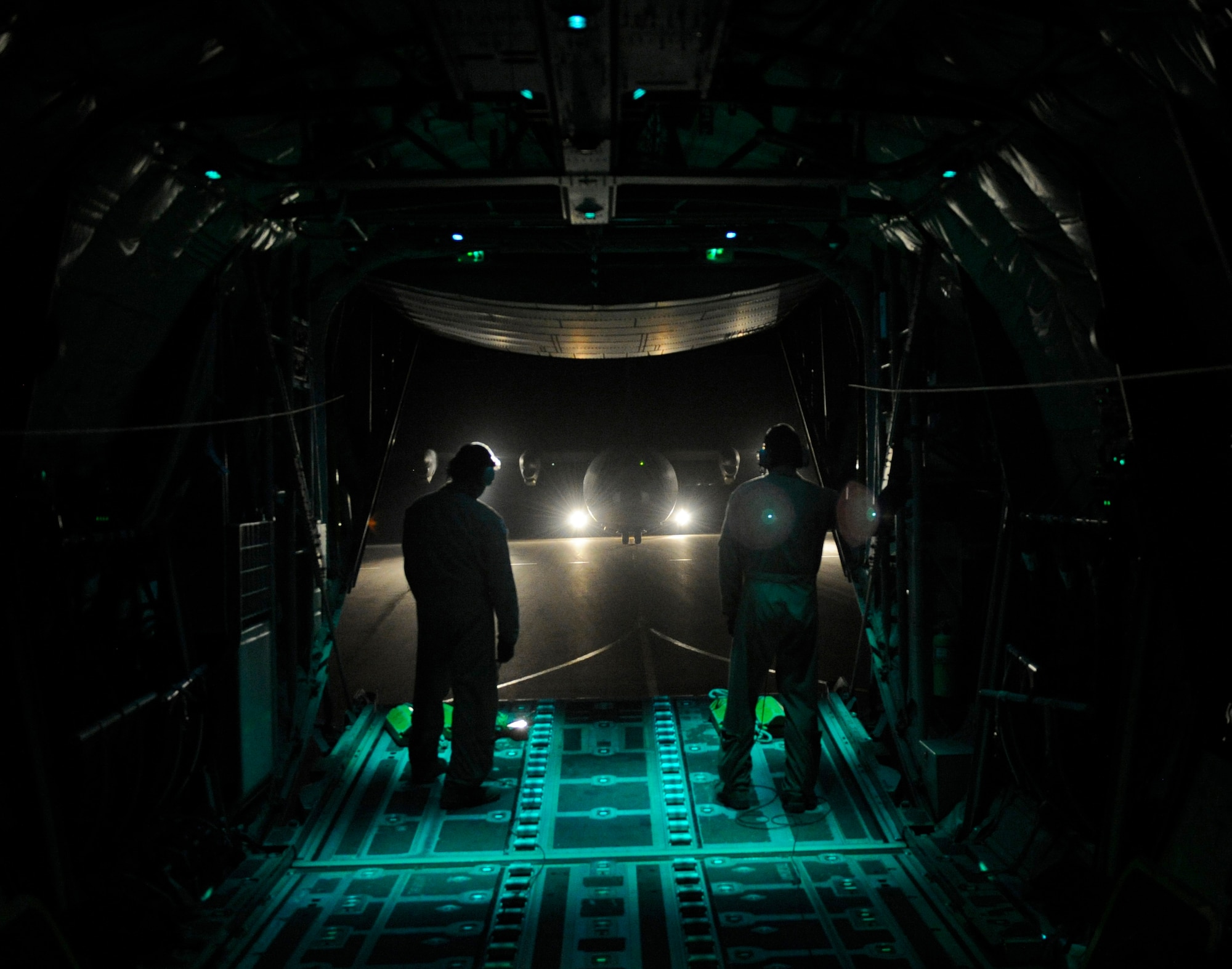 U.S. Air Force Staff Sgts. Luis Murrillo, left, and Max Gomez, 37th Airlift Squadron aircraft load masters, prepares to park a C-130J Hercules during Exercise Noble Shirley 2015, May 10, 2015. The sergeants were the load masters for a night flight which consisted of the use of night vision goggles, low level flying, max effort assault zone landings and container delivery system drops. (U.S. Air Force photo/Tech. Sgt. Patrick Mitchell)