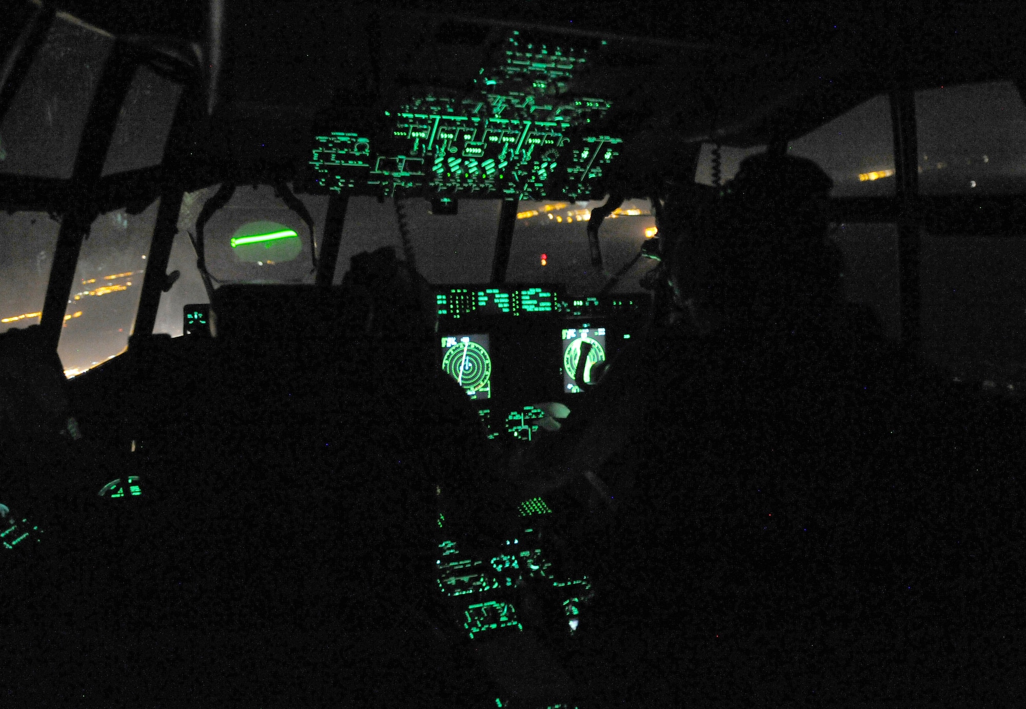 U.S. Air Force Capts. Clayton Martin, left, and Joe Eastman, 37th Airlift Squadron pilots, preform a night flight during Exercise Noble Shirley 2015, May 10, 2015. The night flight included the use of night vision goggles, low level flying, max effort assault zone landings and container delivery drops. (U.S. Air Force photo/Tech. Sgt. Patrick Mitchell)