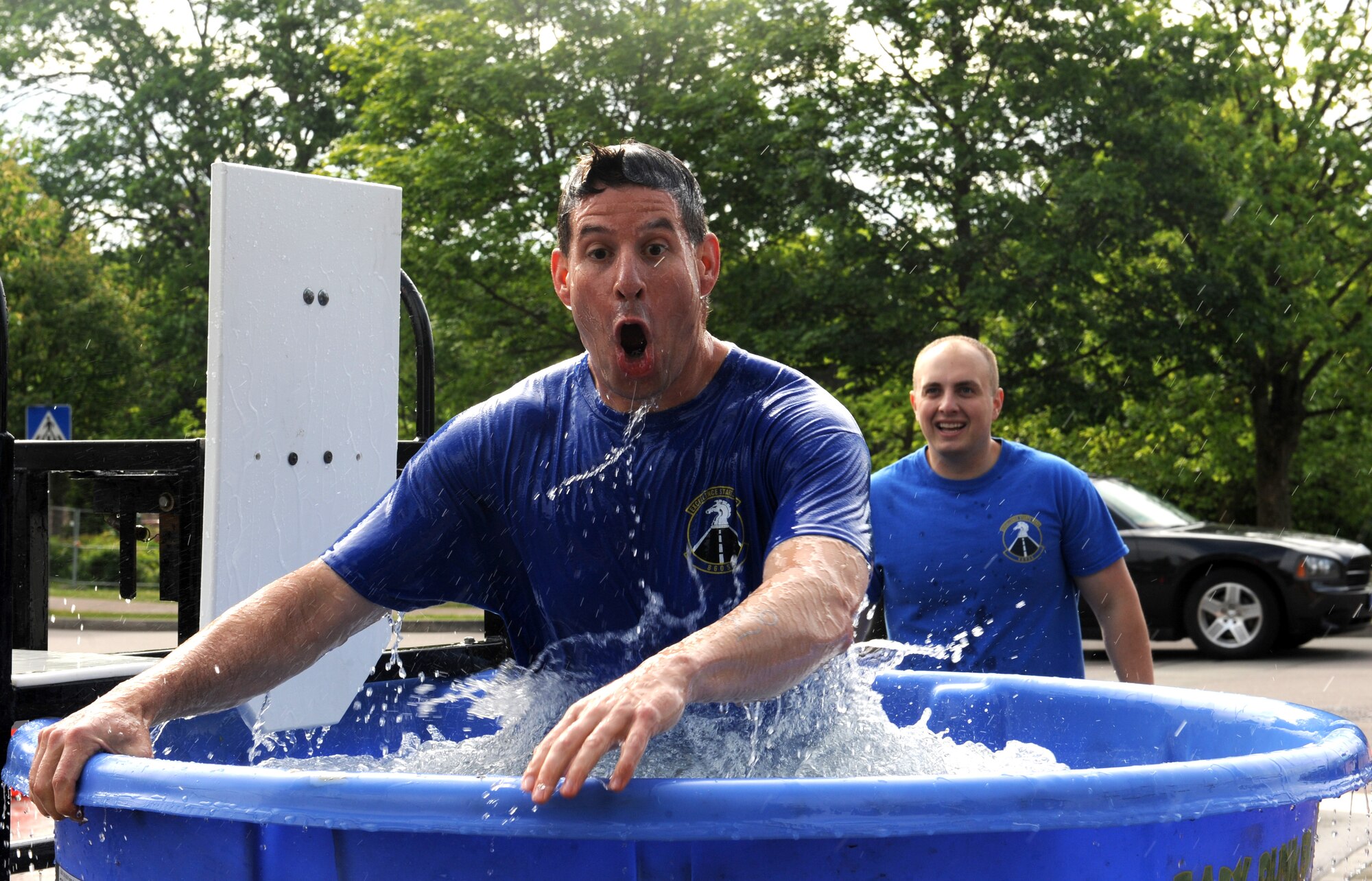 An Airman exits the dunk tank during the Mudless Mudder event June 2, 2015, at Ramstein Air Base, Germany. Mudless Mudder was part of the 86th Airlift Wing's Resiliency Day, which gave members an opportunity to strengthen team building. (U.S. Air Force photo/Staff Sgt. Sharida Jackson)