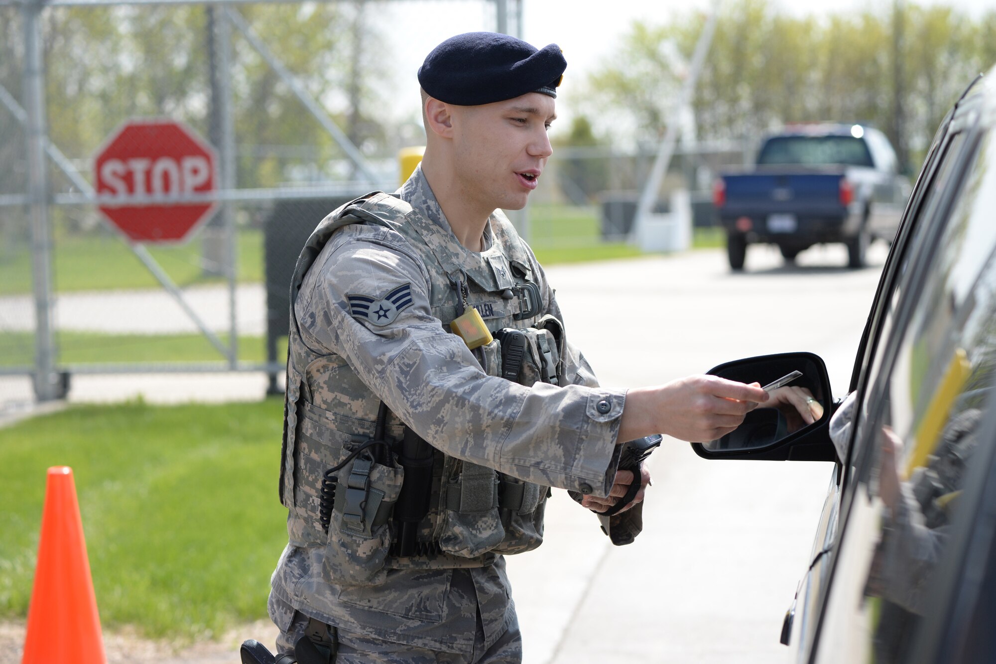 Senior Airman Michael Bullen, of the 119th Security Forces Squadron, checks the identification of personnel entering the North Dakota Air National Guard Base, Fargo, North Dakota, May 12, 2015. (U.S. Air National Guard photo by Senior Master Sgt. David H. Lipp/Released)