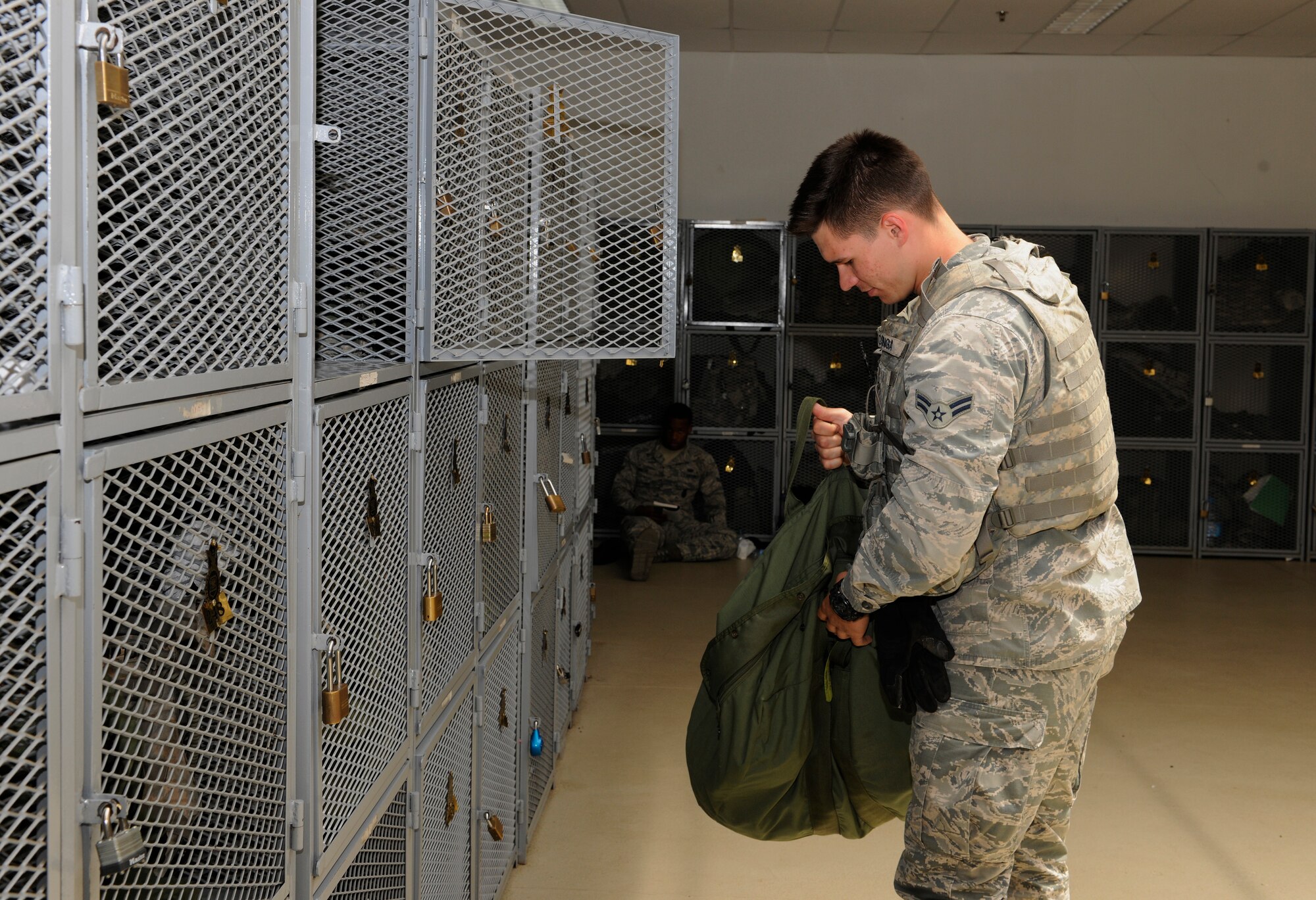 Airman 1st Class Justin Osinga, 39th Security Forces Squadron vault storage area supervisor, gathers personal protective equipment from his locker while gearing up before his shift May 18, 2015, at Incirlik Air Base, Turkey. The proper storage of PPE is important to maintaining a quick response time for SFS defenders.  (U.S. Air Force photo by Senior Airman Krystal Ardrey/Released)