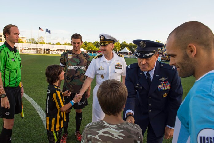 Col. John Lamontagne, 437th Airlift Wing commander, greets officials, team captains and ball boys prior to the Charleston Battery soccer team's military appreciation night held at Blackbaud Stadium on Daniel Island, S.C., May, 30 2015. The team wore camouflage uniforms and provided free tickets to any service member, retiree or spouse who presented a military ID. Charleston Battery won the match 1-0. (U.S. Air Force by Staff Sgt. William A. O’Brien)