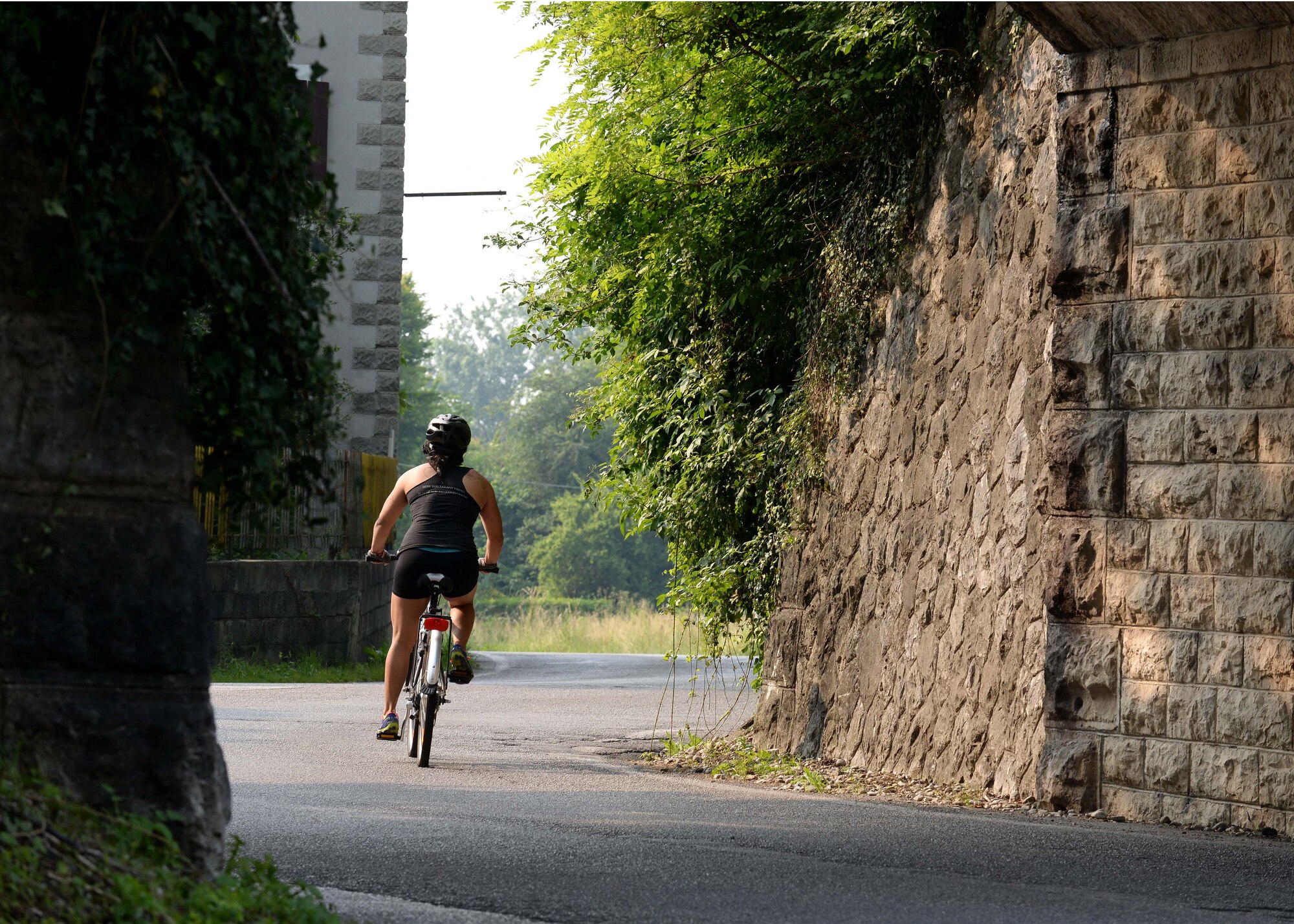 A triathlon competitor pedals through an intersection to complete the second leg of Aviano’s 2nd Annual Triathlon, May 30, 2015, at Aviano Air Base, Italy.  Approximately 45 people competed in this year’s triathlon, where they swam 500 meters, biked 16 kilometers and ran five kilometers. (U.S. Air Force photo by Airman 1st Class Cary Smith/Released)