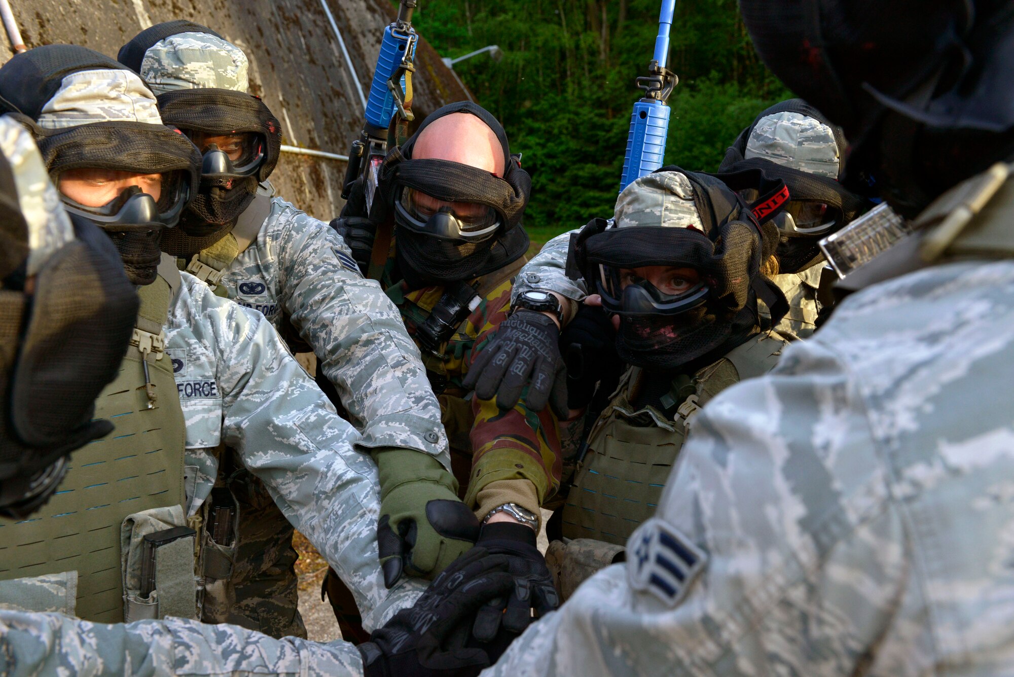 A group of U.S. Airmen and a German soldier huddle together before they begin training operations during Battlefield Leaders Assaulter Course, Integrated Combat Essentials May 30, 2015, at Ramstein Air Base, Germany. The BLAC ICE training brings together  U.S. Air Force security forces members with Belgium, Germany, the Netherlands and Italy security forces members to train on advanced tactics, shooting and leadership skills. (U.S. Air Force photo by Airman 1st Class Lane T. Plummer/Released)